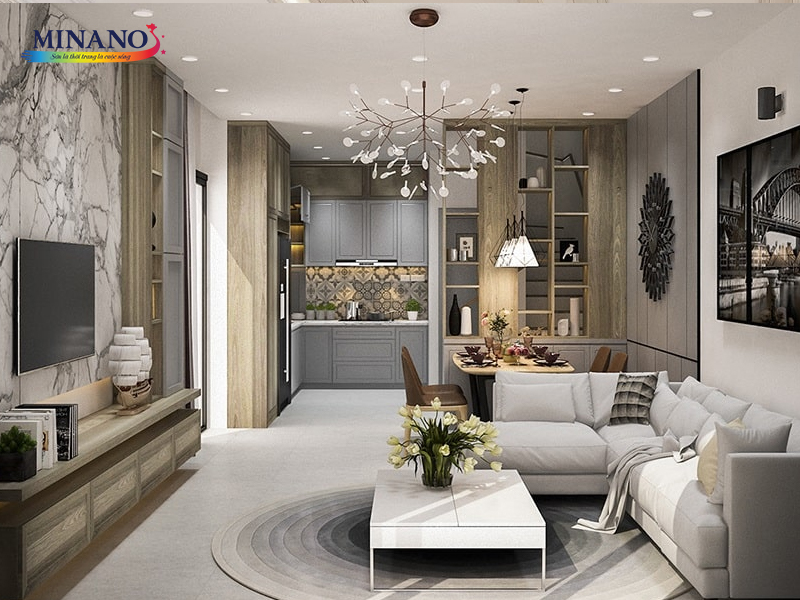 Sơn chung cư phòng khách thanh lịch và tinh tế với tone màu trắng làm chủ đạo, kết hợp cùng sơn giả đá sang trọng. Tường và trần được sơn màu trắng, tạo nền cho không gian tươi sáng và rộng rãi